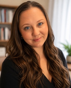 Ally Hart, smiling, photographed in front of a bookshelf.
